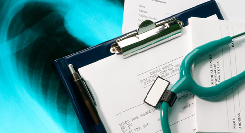 Stethoscope on top of a form, on top if an xray of a ribcage