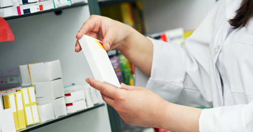 Pharmacist holding box of medication